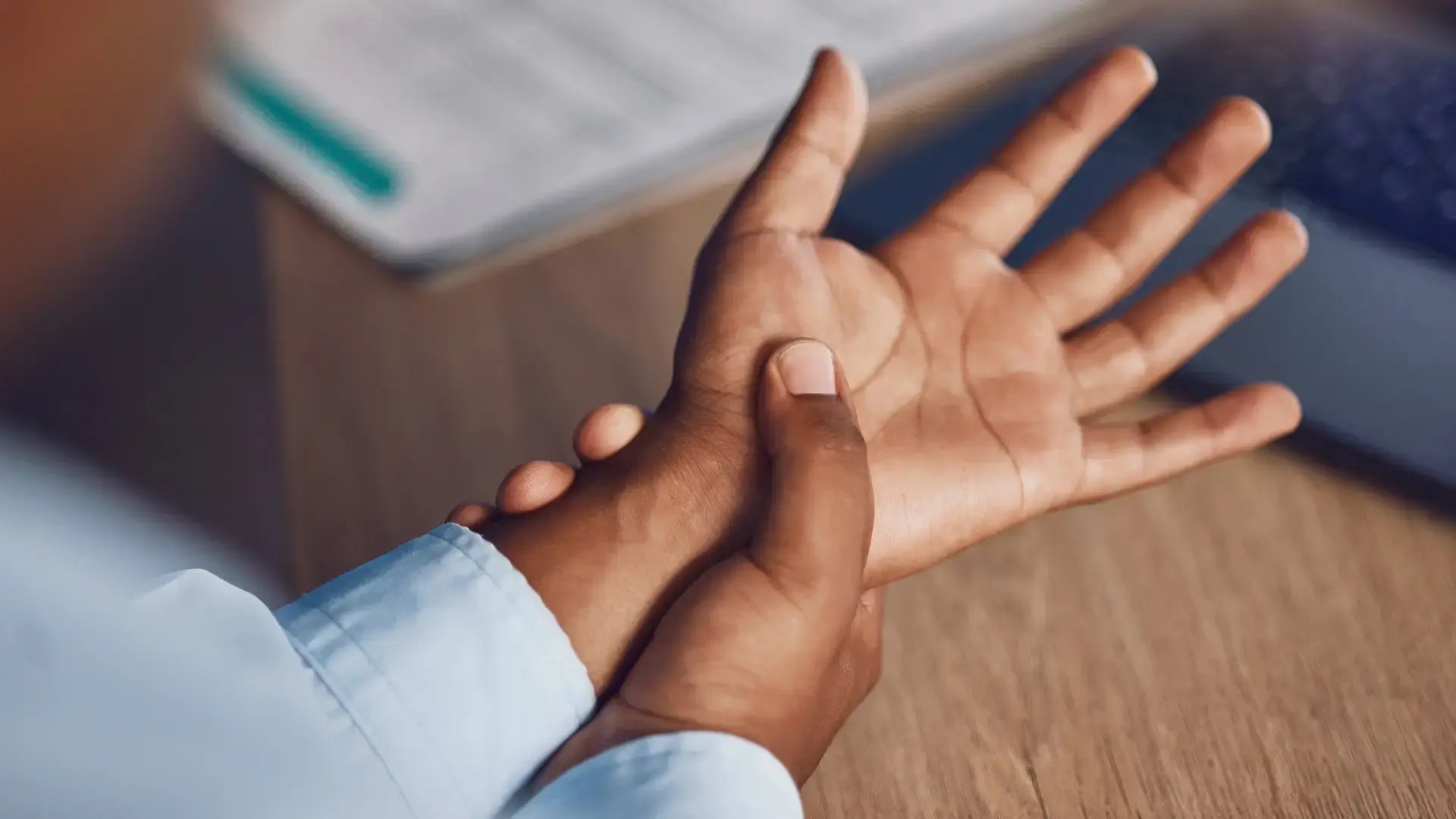 Hand, pain and businessman in office with anatomy, risk or fibromyalgia stress, disaster and carpal tunnel discomfort from above